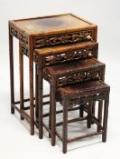 A GOOD NEST OF FOUR CHINESE HARDWOOD RECTANGULAR TABLES, with faux bamboo carved frames, fruiting