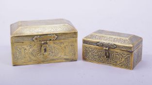 TWO ISLAMIC BRASS LIDDED BOXES, with hinged lids and each engraved with calligraphy and decorative