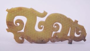 A CHINESE CARVED JADEITE PLAQUE, depicting a dragon, 16.5cm long.