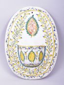 A TURKISH OTTOMAN KUTAHYA HANGING WATER STOUP, decorated with foliate motifs, 27cm x 20cm.