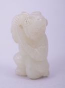 A SMALL CHINESE JADE FIGURAL CARVING, 4cm high.