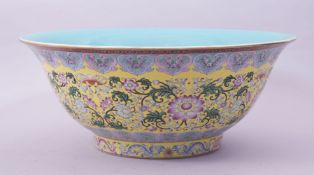 A VERY LARGE CHINESE FAMILLE ROSE AND YELLOW GROUND PORCELAIN BOWL, the exterior decorated with
