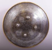 A SUPERB PERSIAN QAJAR STEEL AND GOLD OVERLAID SHIELD, with engraved decoration, the centre with