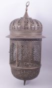 AN ISLAMIC OPENWORK METAL HANGING LANTERN.