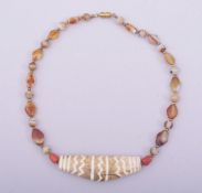 A TIBETAN AGATE BEADED NECKLACE.
