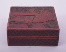 A 19TH CENTURY CHINESE CINNABAR LACQUER SQUARE FORM BOX AND COVER, the lid with figures in a