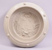 A JAPANESE CELADON GLAZE BOWL, with moulded decoration of phoenix and kylin, the rim with five