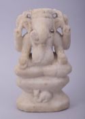A 17TH/18TH CENTURY INDIAN CARVED MARBLE GANESHA, 18.5cm high.