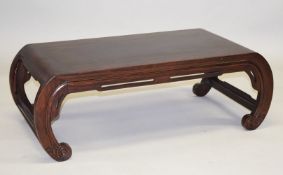 A GOOD CHINESE HARDWOOD LOW TABLE, on four curving end supports, 97cm long, 33cm high, 50cm deep.