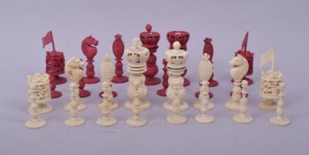 A MIXED LOT OF CARVED IVORY CHESS PIECES, comprising 16 white pieces and 14 stained red pieces.