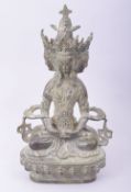A TIBETAN BRONZE FOUR HEADED SEATED BUDDHIST DEITY, 22.5cm high.