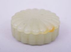 A SMALL CHINESE OR INDIAN CARVED JADE BOX AND COVER, 5cm diameter.
