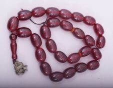 A CHERRY AMBER BAKELITE LARGE BEADED NECKLACE.