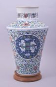 A CHINESE FAMILLE VERTE PORCELAIN VASE AND WOODEN STAND, the vase decorated with roundels containing