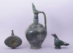 AN ISLAMIC GREEN GLAZED POTTERY EWER, together with two other green glazed pottery pieces, ewer 33cm