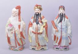 THREE CHINESE PORCELAIN FIGURES, including a figure of Shoulau holding a staff and peach, 24.5cm