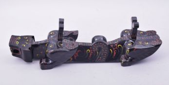 A CHINESE LACQUERED WOOD STAND, in the form of a beast, 55.5cm long.