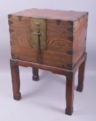 A CHINESE HARDWOOD CASKET ON STAND, with brass fittings and pin lock with key, casket 28cm high,