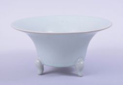 A CHINESE CELADON CIRCULAR BRUSH WASHER, the bowl supported on three feet, with incised mark to