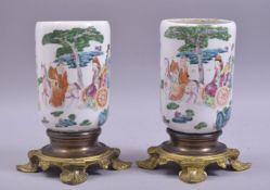 A PAIR OF CHINESE FAMILLE ROSE PORCELAIN VASES, mounted to ormolu stands, the body of each painted