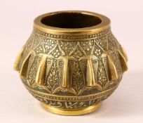 A 19TH CENTURY PERSIAN QAJAR ENGRAVED BRONZE MORTAR - with multi head decoration 12cm