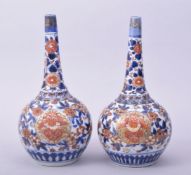 A SMALL PAIR OF IMARI PORCELAIN BOTTLE VASES, each approx. 22cm high.
