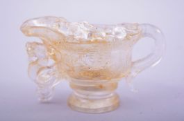 A CHINESE CUT GLASS LIBATION CUP.