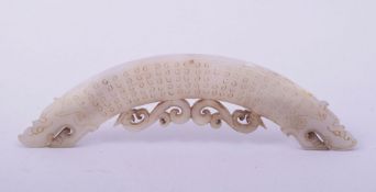 A CHINESE CARVED JADE AMULET, with twin dragon or lion dog heads and pierced phoenix motif, 16cm