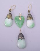 A CHINESE SET OF THREE METAL MOUNTED JADE PENDANT EARRINGS, together with another green pendant (