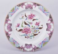 A CHINESE FAMILLE ROSE PORCELAIN PLATE, the centre painted with flora, 22.5cm diameter.