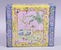 A CHINESE FAMILLE ROSE SQUARE FORM PORCELAIN PILLOW, painted with a panel of a deer in an outdoor