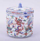 A CHINESE WUCAI PORCELAIN RIBBED CYLINDRICAL BOX AND COVER, the exterior painted with dragon and