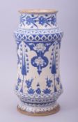 A TURKISH BLUE AND WHITE POTTERY MEDICINE JAR, decorated with floral motifs, 26.5cm high.