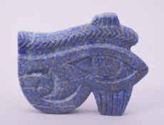A CARVED LAPIS EYE OF HORUS, the underside unworked, 8.5cm x 7cm.