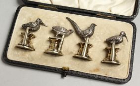 A SUPERB SET OF FOUR CAST SILVER BIRD MENU HOLDERS, each 2.5cm high in original case.