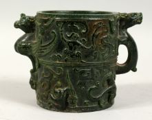 A CHINESE TWO HANDLED CIRCULAR JADE BRUSH POT with figures, birds etc. in relief. 5ins