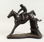 A GOOD BRONZE HORSE AND JOCKEY OVER STICKS. 11ins high.