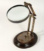 A MAGNIFYING GLASS on a stand.