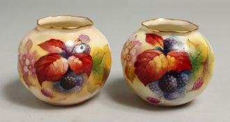 A PAIR OF ROYAL WORCESTER VASES painted with autumnal leaves and berries by Kitty Blae. Signed K.