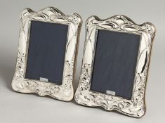 A LARGE PAIR OF SILVER PHOTOGRAPH FRAMES. 19cm x 14cm.