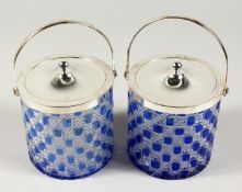 A PAIR OF BLUE GLASS AND CUT GLASS CIRCULAR BISCUIT BARRELS with plated lids and handles.