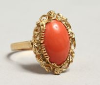 AN 18CT GOLD CORAL SET OVAL RING