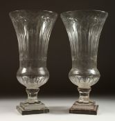A GOOD PAIR OF CUT GLASS THISTLE-SHAPED VASES on stepped square bases. 17ins high.