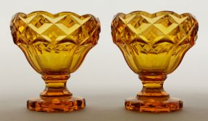 A PAIR OF BOHEMIAN AMBER GLASS PEDESTAL SALTS