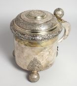 A LARGE SWEDISH SILVER TANKARD the top inset with a medallion, bell knop and three ball feet. Weighs