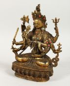 A MULTI ARMED DEITY on an oval base, with turquoise beads. 9ins high.
