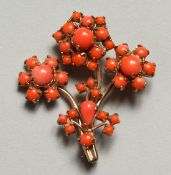 A CORAL FLOWER BROOCH.