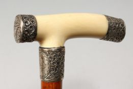 A VICTORIAN IVORY AND SILVER HANDLED WALKING STICK. Birmingham 1886. 34ins long.