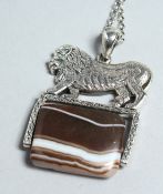 A SILVER LION BRANDED AGATE PENDANT AND CHAIN.