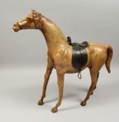 A GOOD LARGE LEATHER HORSE, POSSIBLY LIBERTY, with leather saddle. 27ins high.
